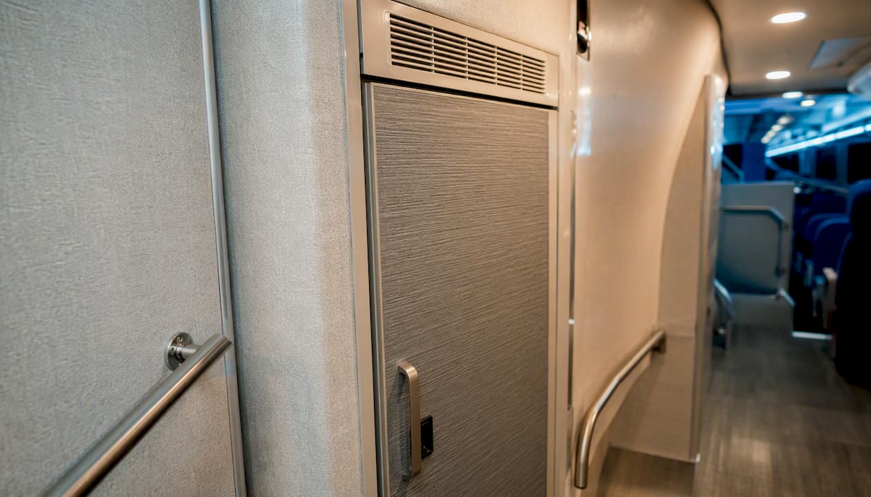 Onboard restroom door in charter bus aisle