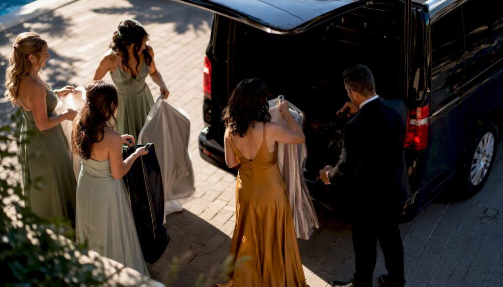 Bridal party boarding high-roof luxury van
