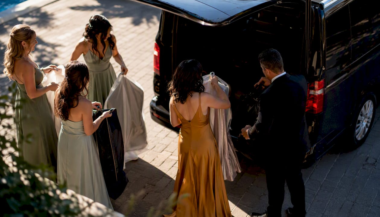 Bridal party boarding high-roof luxury van