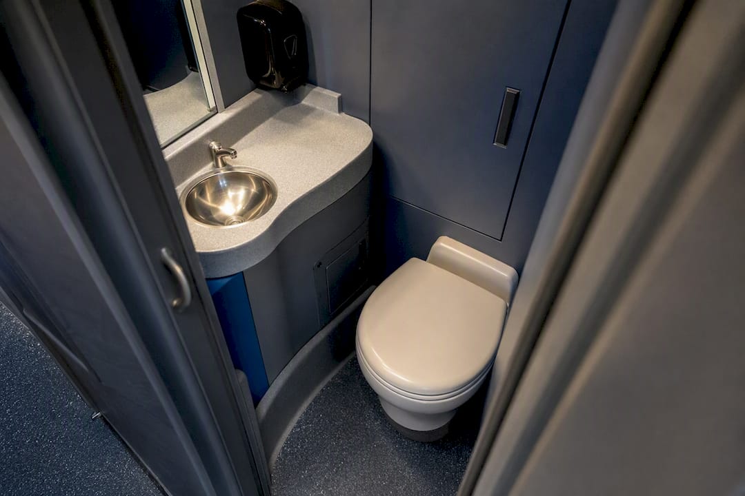 Compact charter bus restroom interior