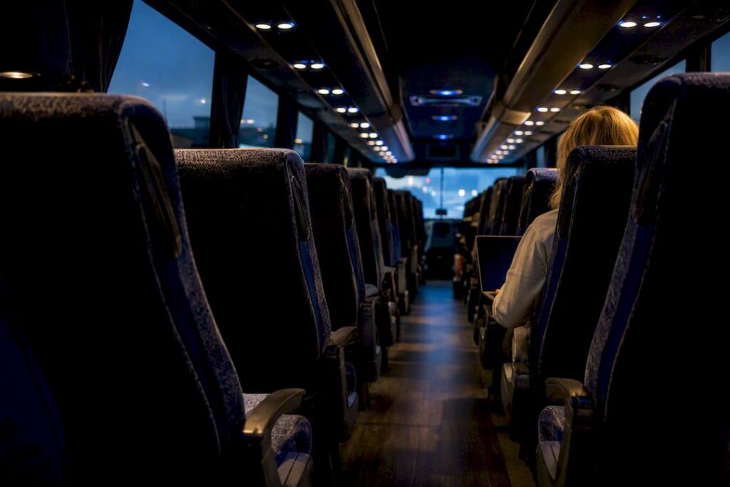 Charter bus interior with cushioned seats and armrests