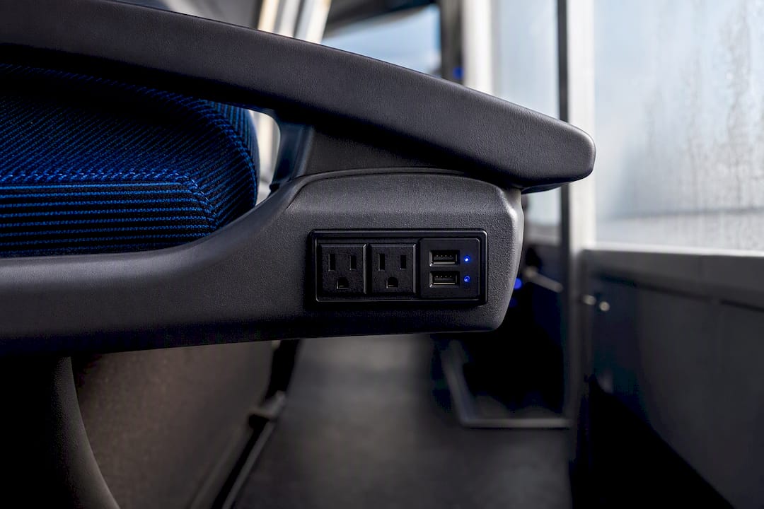 Power outlets and USB ports near bus seat