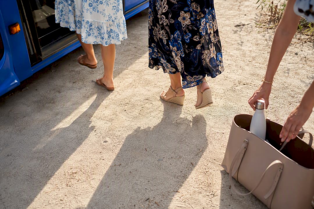 Guests' feet on gravel path near shuttle
