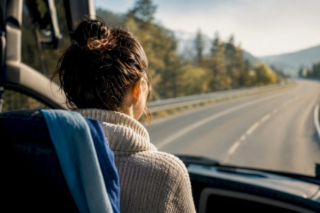 Passenger viewing road from front bus seat