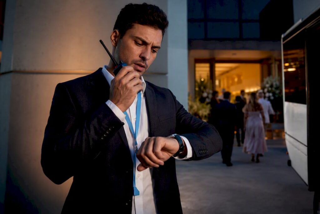 Coordinator managing shuttle arrivals at wedding venue