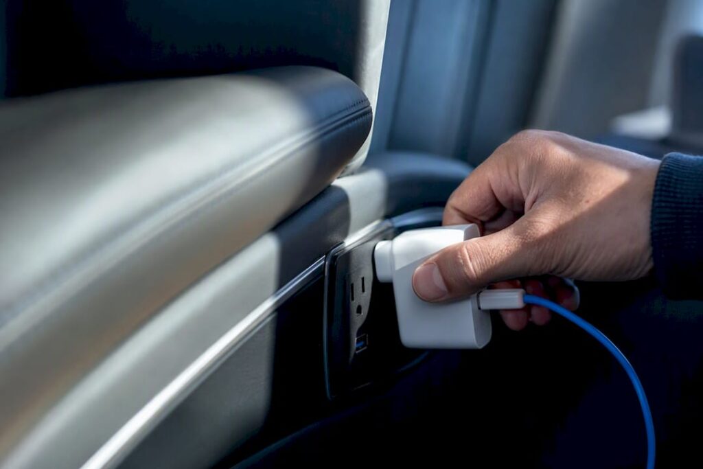 Traveler checking a coach charging outlet