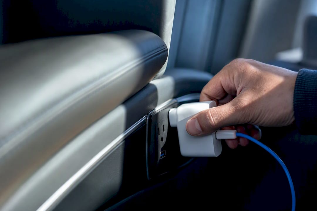 Traveler checking a coach charging outlet